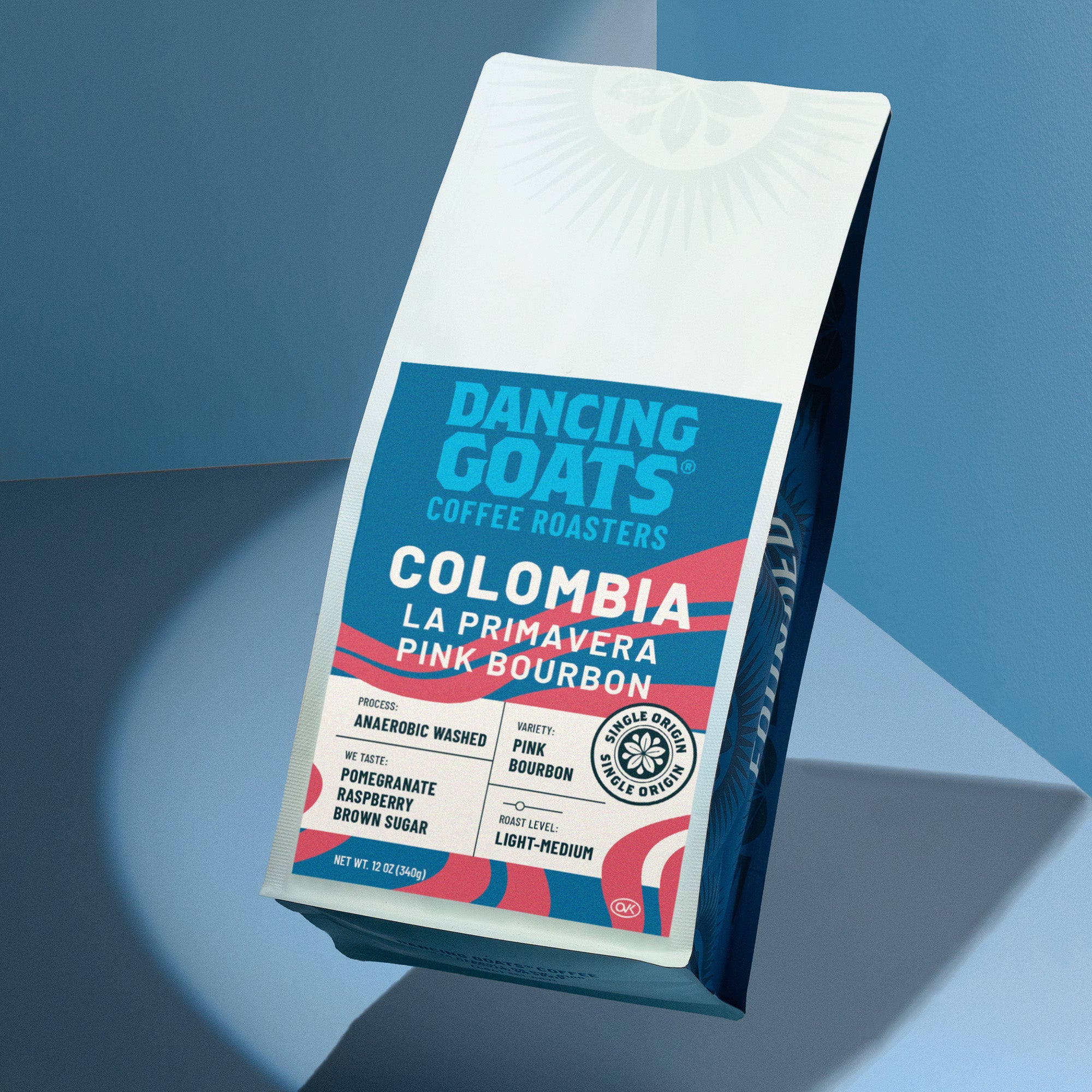 Dancing Goats Coffee Roasters Colombia La Primavera Pink Bourbon coffee bag on a blue gradient background