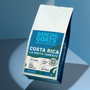 Dancing Goats Coffee Roasters Costa Rica coffee bag on a blue gradient background