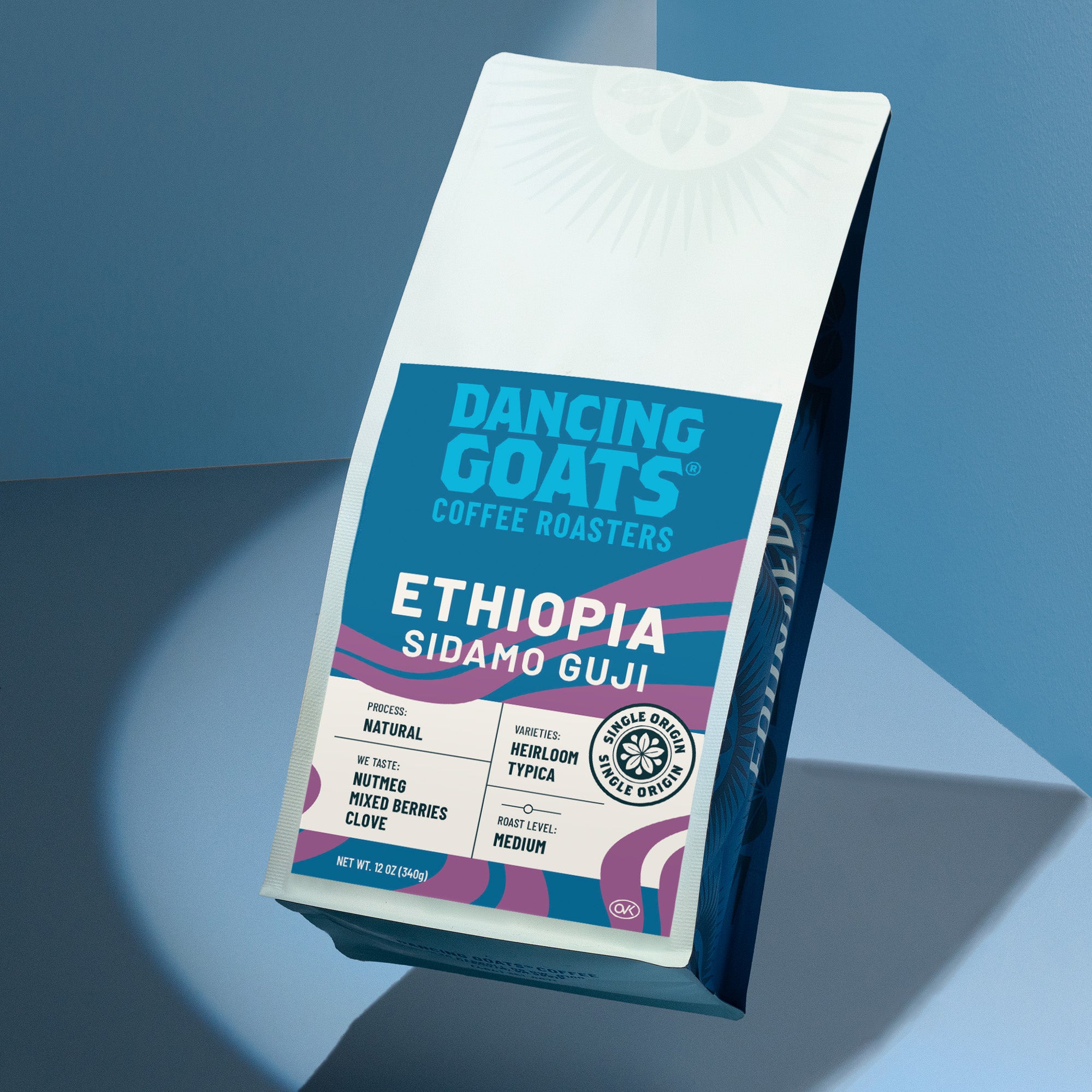Dancing Goats Coffee Roasters Ethiopia Sidamo Guji coffee bag on a blue gradient background