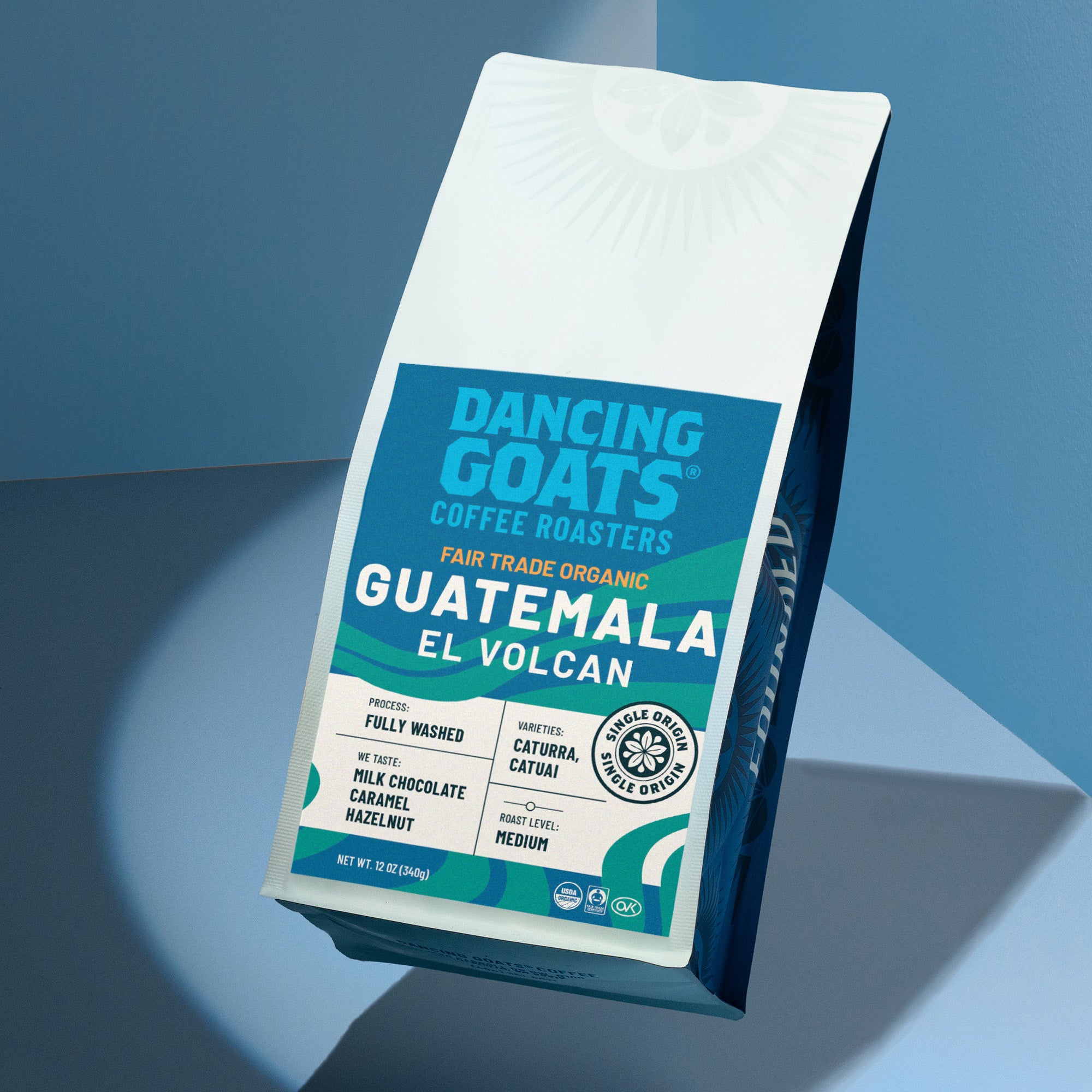 Dancing Goats Coffee Roasters Guatemala El Volcan coffee bag on a blue gradient background