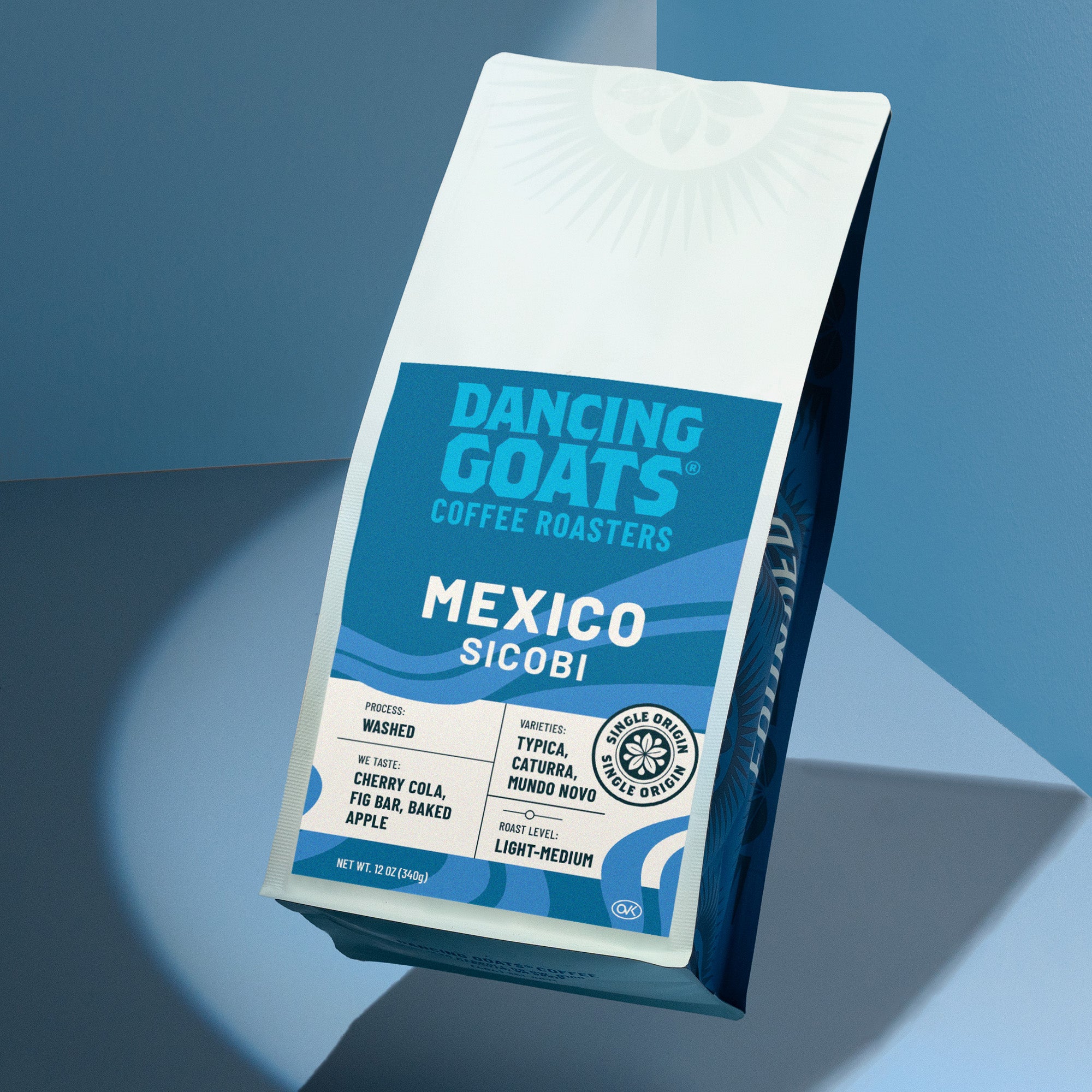 Dancing Goats Coffee Roasters Mexico Sicobi coffee bag on a blue gradient background
