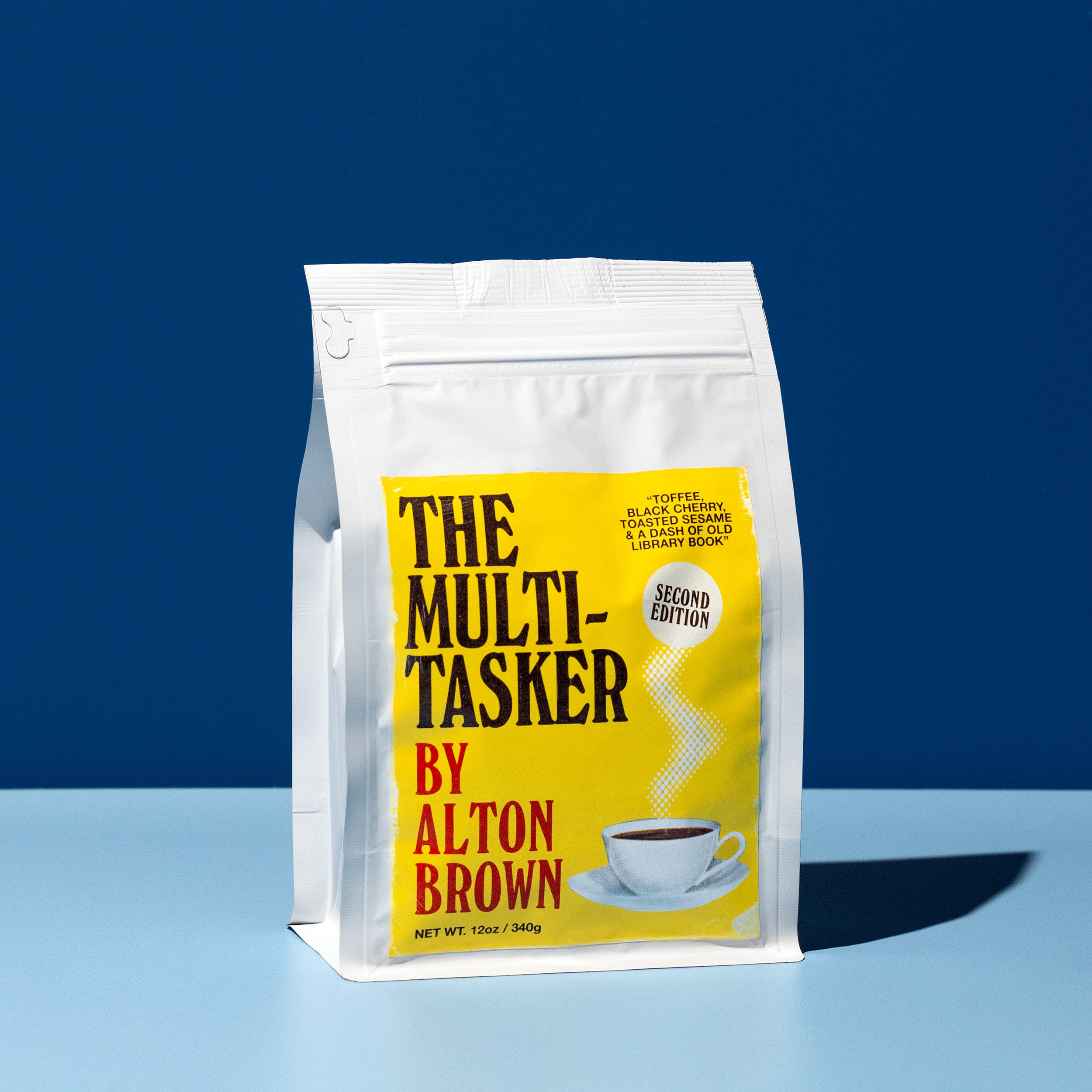 Coffee bag labeled 'The Multitasker by Alton Brown' on a blue background