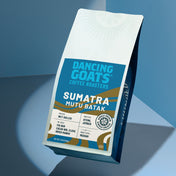 Dancing Goats Coffee Roasters Sumatra Mutu Batak coffee bag on a blue gradient background