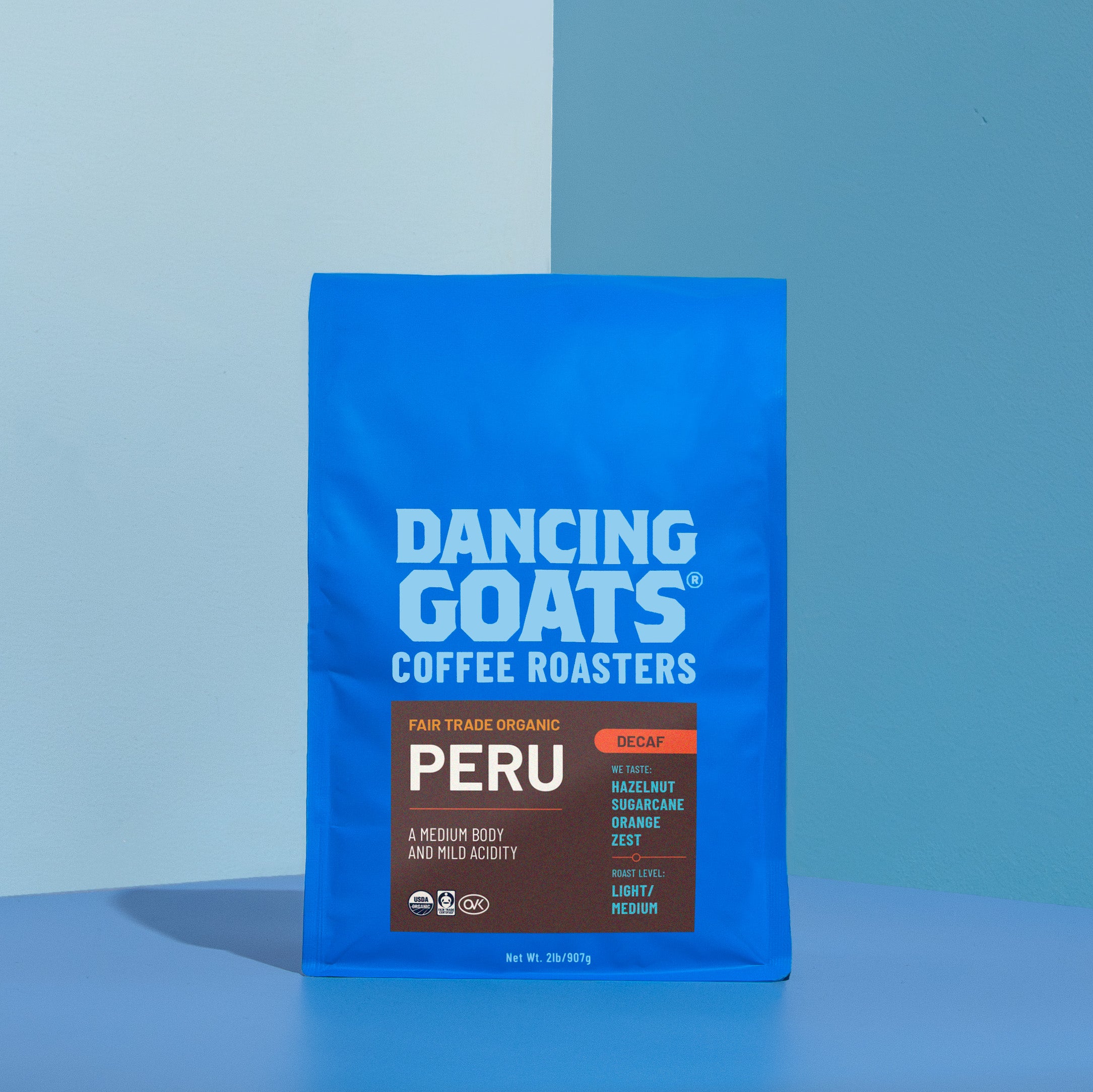 Blue bag of Dancing Goats Coffee Roasters Peru coffee on a blue background