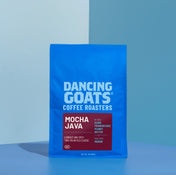 Blue package of Dancing Goats Coffee Roasters Mocha Java on a blue background