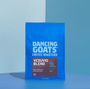 Blue coffee bag labeled 'Dancing Goats Coffee Roasters Vesuvio Blend' on a blue background