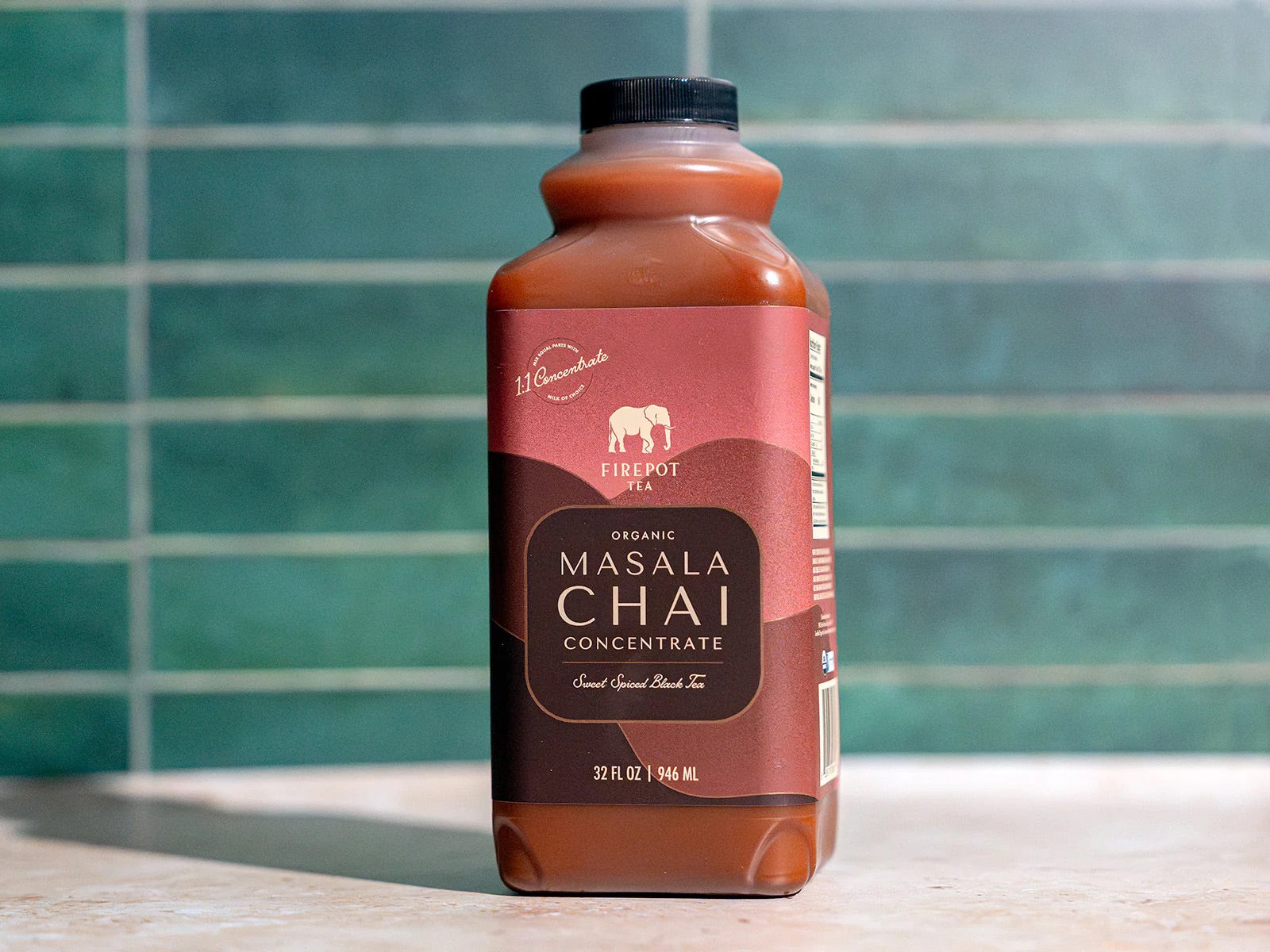 32oz chai concentrate bottle on green background