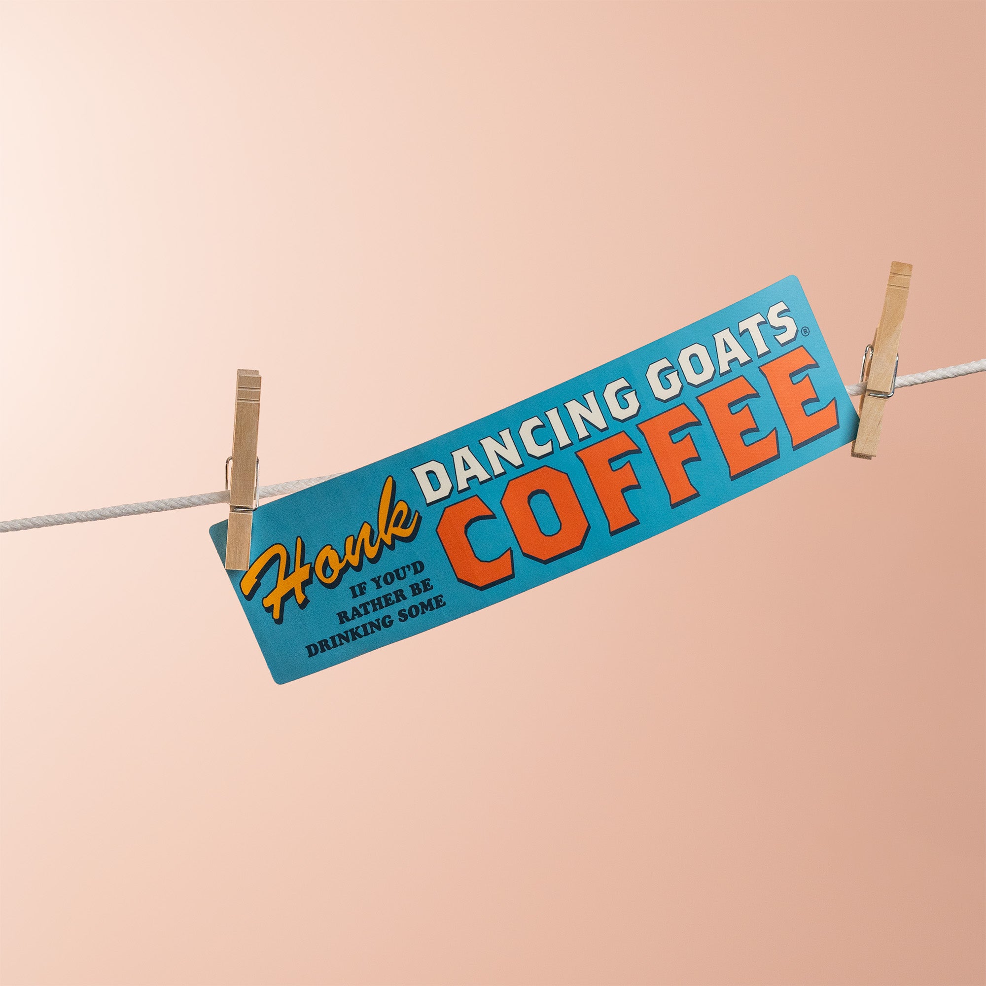 Bumper sticker with 'Honk if you'd rather be drinking Dancing Goats Coffee' text on a beige background