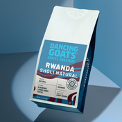 rwanda sholi natural label on dancing goats coffee bag on blue background