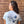 back of person wearing Dancing Goats light blue boxy fit cropped tee