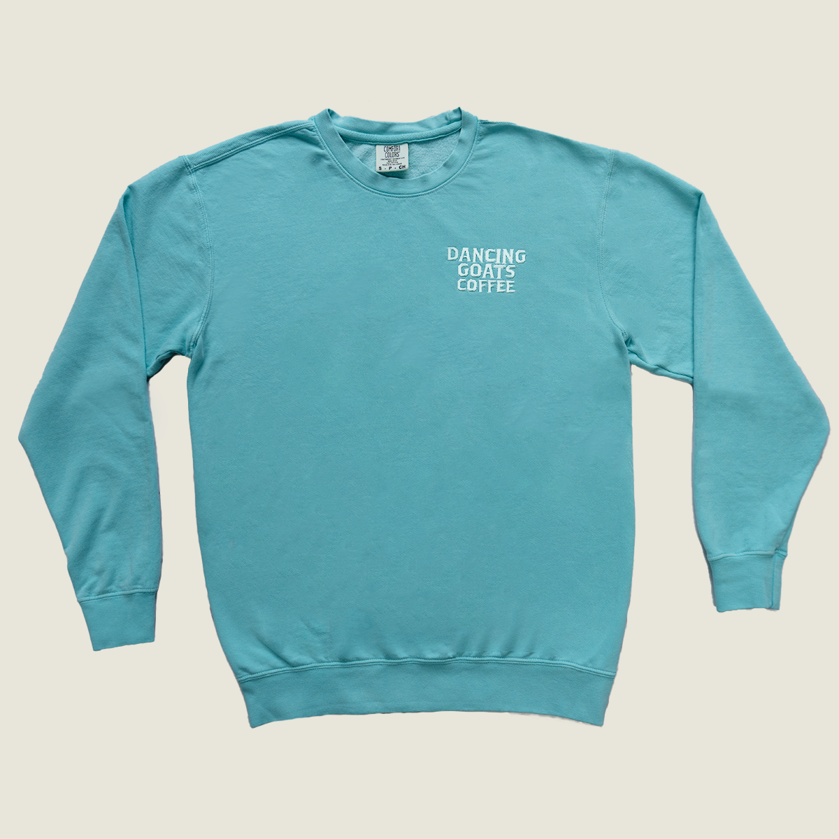 Blue sweater with Dancing Goats Coffee embroidery