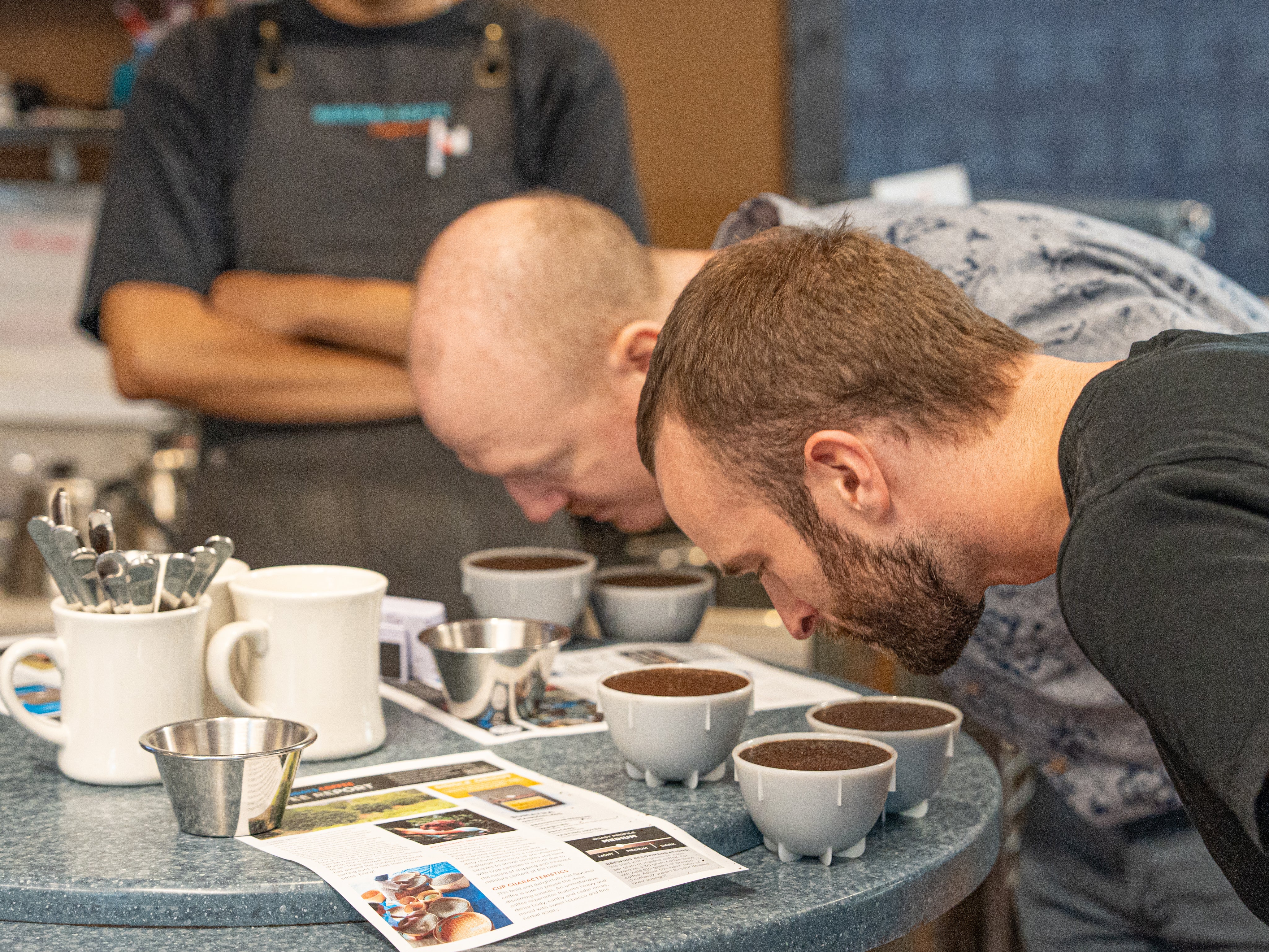 image of people trying coffee during. a cupping