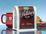Dancing Goats Coffee Roasters Holiday Blend 2025 coffee package on a blue background