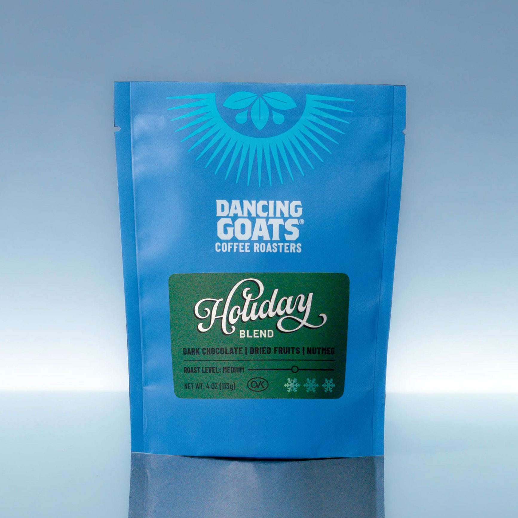 Blue packaging of Dancing Goats Coffee Roasters Holiday Blend on a light blue background