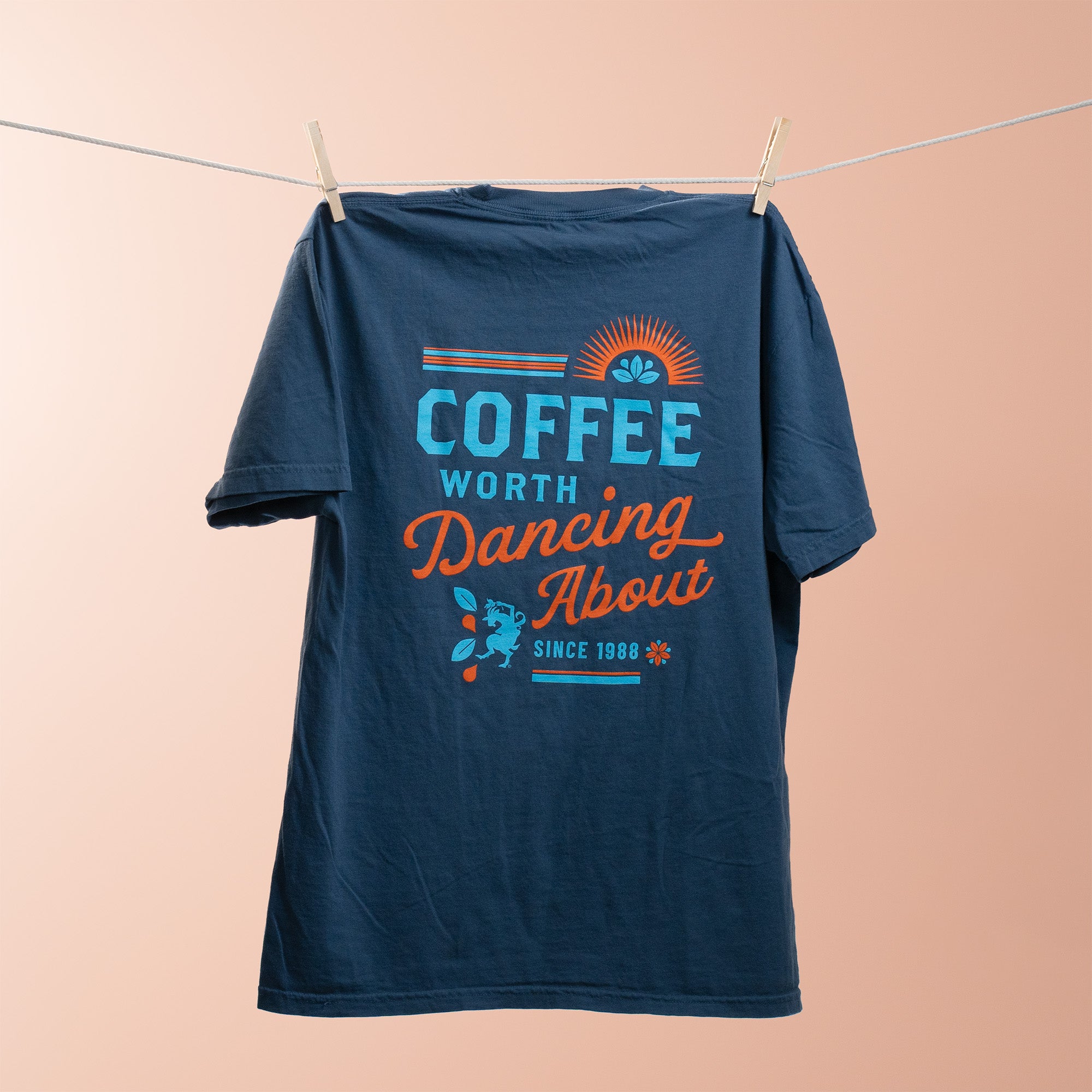 Navy blue t-shirt with colorful text design on a beige background